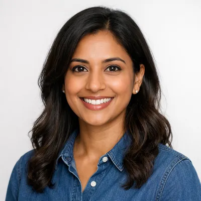 Professional photorealistic avatar portrait featuring a diverse adult with a warm smile and casual attire against a soft gray